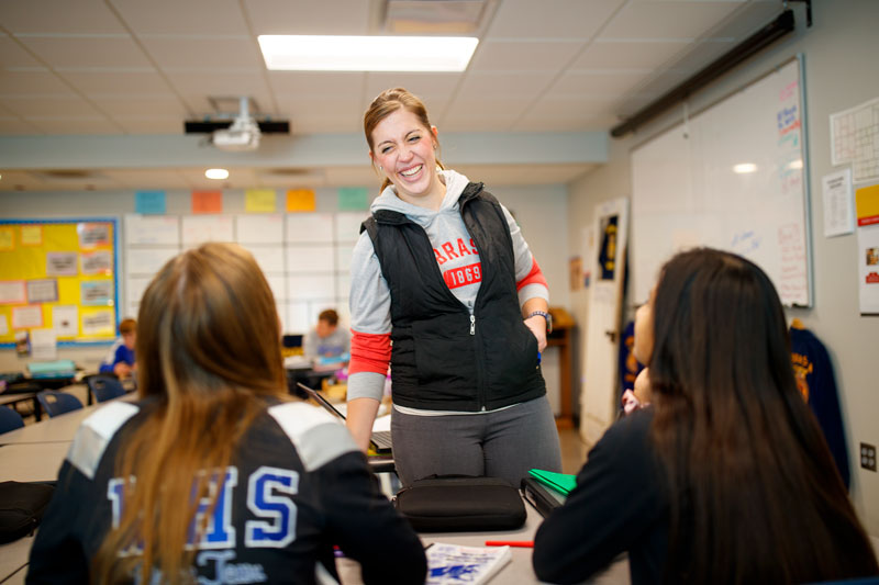 Teacher in classroom with students.