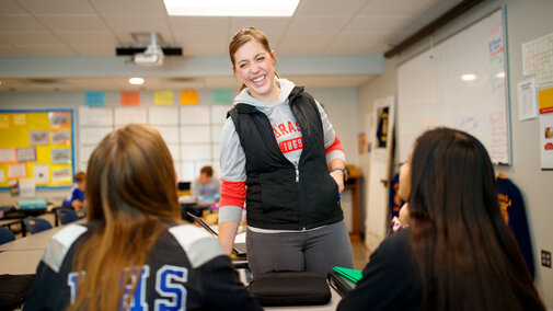 Teacher in classroom with students.