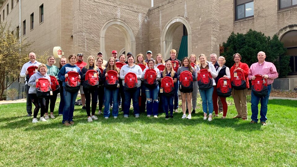 Picture of ALEC preservice teachers showing off backpacks.