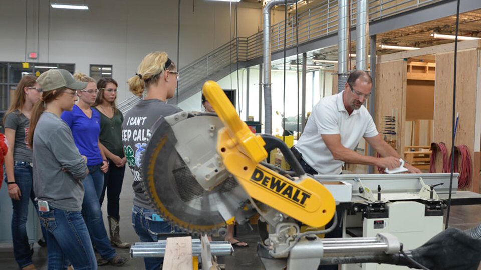 Eric Knoll teaching students in machine shop.