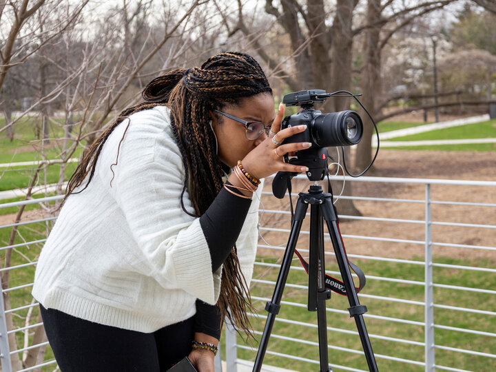 Student setting up a camera.