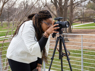 Student setting up a camera.