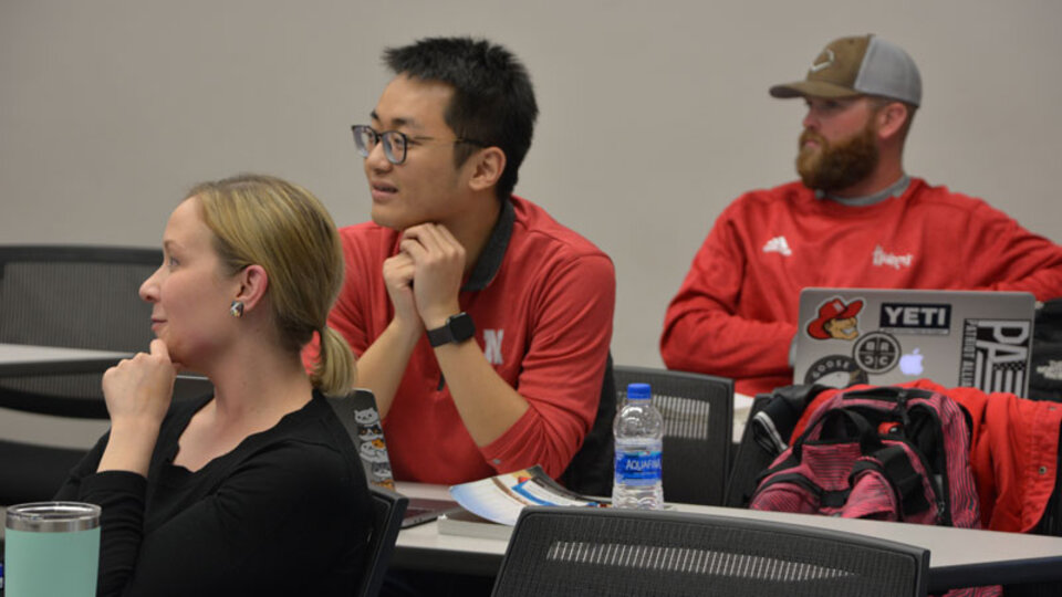 Students sitting in a classroom listening to professor.