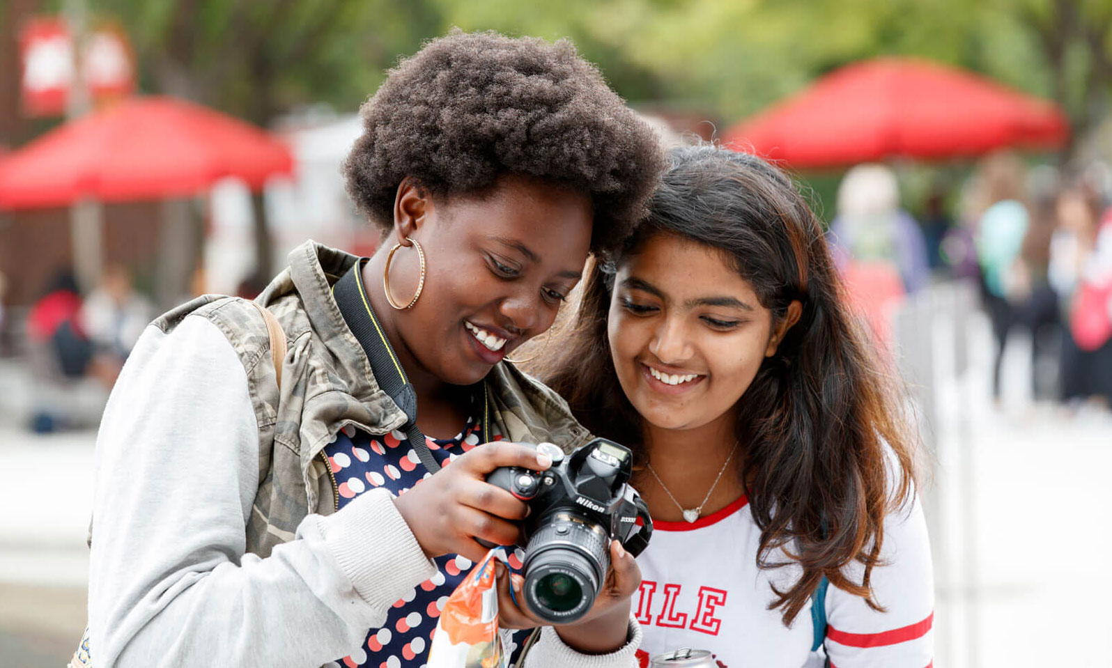 Two students using an SLR camera.